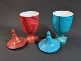 four pieces of art glass sitting on top of a table