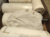 several rolls of paper are wrapped in plastic and sitting in a wooden box