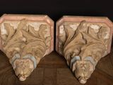 pair of antique carved wood corbs with floral designs on the sides