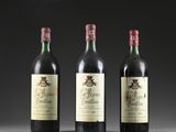 three bottles of wine sit side by side on a table