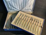 des couverts dans un étui bleu posé sur une table, contenant un couteau et une fourchette