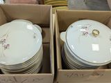 many plates and bowls in a box on the table