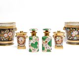 five vases and two containers sitting next to each other