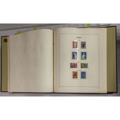 an open book with stamps on it on a table