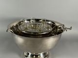 an antique silver plated bowl with handles and handles on a stand