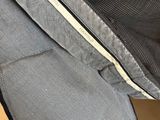 the back of a backpack with a zipper on it is hanging from a wall