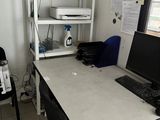 a desk with a laptop and a printer on it