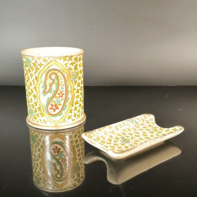 a cup and plate sitting on a black table