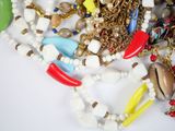 a pile of assorted necklaces and bracelets on a table