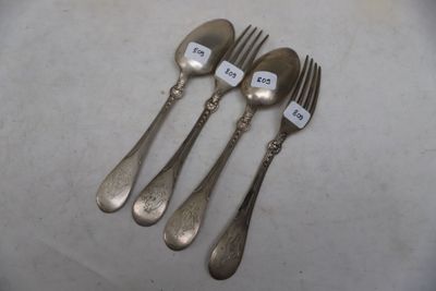 four forks and a spoon with a price tag on them