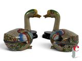 pair of colorfully painted ducks sitting next to each other on a white surface