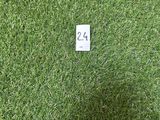 artificial grass with a number 24 on it in front of a white wall