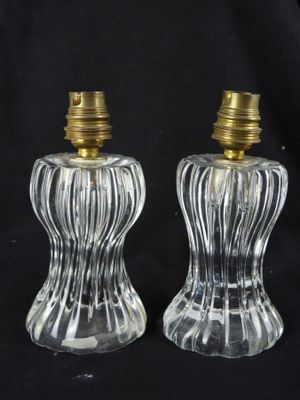 two clear glass salt and pepper shakers with gold tops