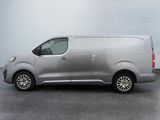 the silver van is parked in a parking lot on a cloudy day