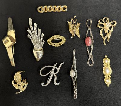 some gold and silver jewelry on a black surface