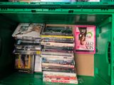 a green box filled with dvd ' s and other movies