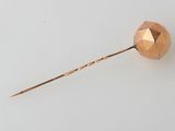 an image of a rose gold hair pin on a white surface