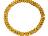a close up of a gold beaded necklace on a white background