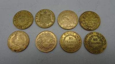a bunch of gold coins sitting on top of a white surface