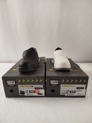 a pair of black and white shoes sitting on top of boxes