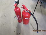 two fire extinguisors sitting on the floor next to each other