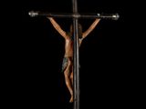 an image of a statue of jesus on a cross on a black background