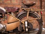 a old motorcycle parked in front of a brick wall