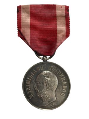 une image représentant une médaille entourée d'un ruban rouge