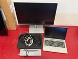 two laptops and a monitor on a red desk