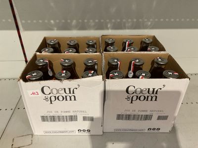 boxes of four cans of soda sitting on top of a counter