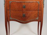 an antique chest of drawers with a marble top