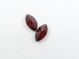 a pair of garnet garnets on a white surface