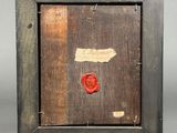 an old wooden frame with a wax stamp and a red wax stamp on it