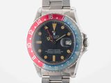 an image of a wrist watch with a red, blue and yellow bezel