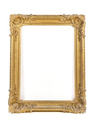 a gold picture frame on a white wall with a white background