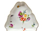 a white plate with flowers on it sitting on a table