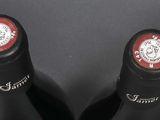 two bottles of wine sitting next to each other on a table