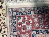 a cat that is laying on a rug on the floor