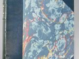 an old book with a blue cover and a marble pattern on it
