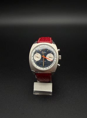 une image représentant une montre avec un bracelet rouge sur un fond noir
