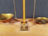 a gold scale with two bowls on top of it