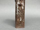 an old metal lighter sitting on top of a white table