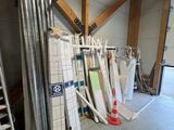 a room with a ladder, ladders, and a pile of tile