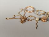 a lot of gold jewelry on a white surface