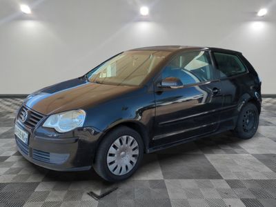 a picture of a small black car parked in a garage