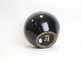 an image of a close up of a black and gold ball