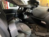 the interior of a car with a steering wheel and a seat in it