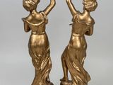 pair of antique bronze figurines of a woman and a bird