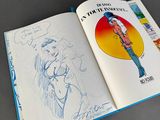 a book with a drawing of a woman in a bikini