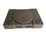 a game console with a game controller on top of it